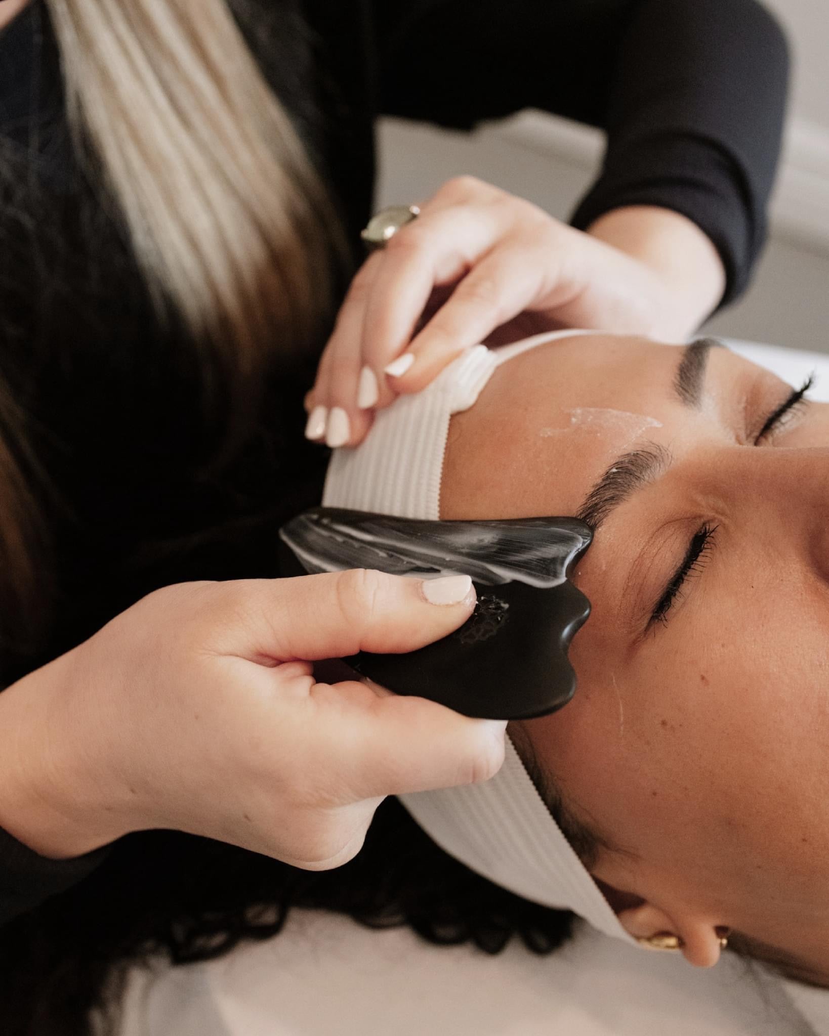 Woman using gua sha