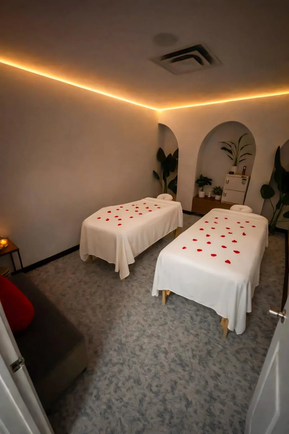 Two massage tables with rose petals in Lluvia’s Walnut Hill treatment room