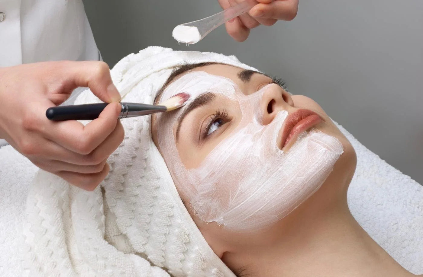 A facial mask being applied with a soft brush